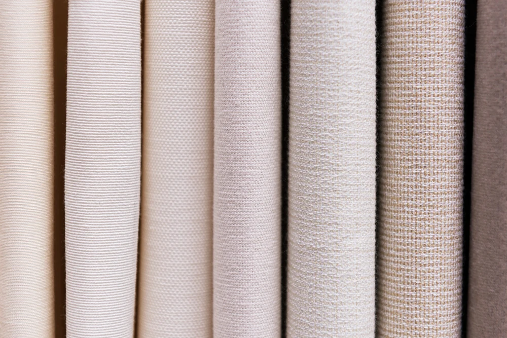 Aligned greige and finished fabric rolls
