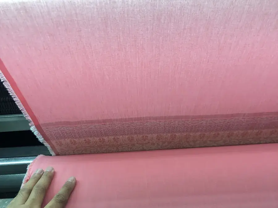 Original hands-on fabric inspection photograph at a selected supplier mill